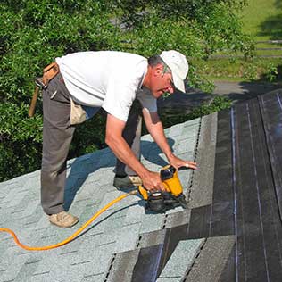 Worker Repairing Roof of a House