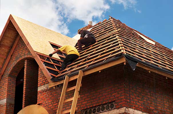 Workers Repairing Residential Roof